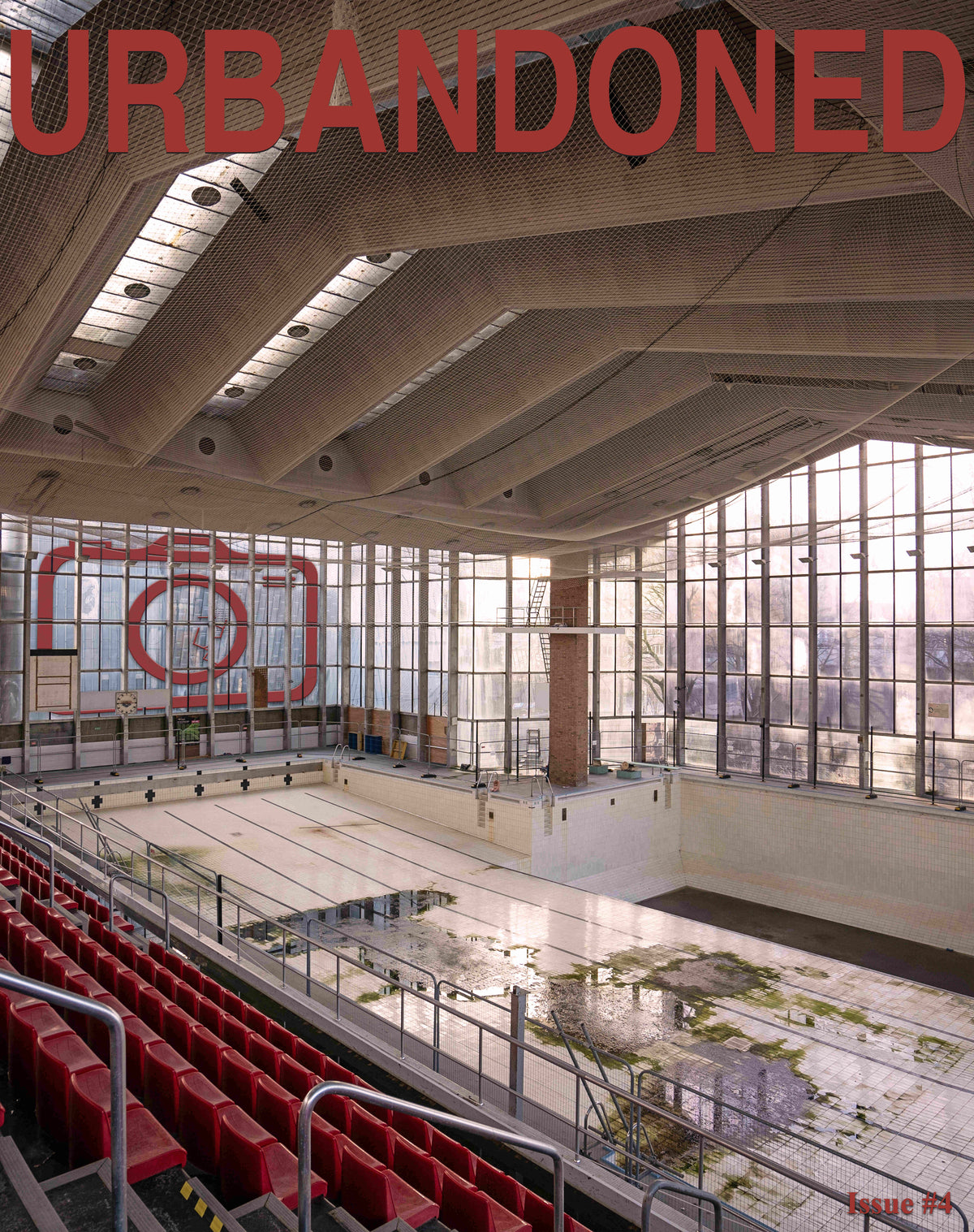 Front cover of Urbandoned Issue 4 showing an empty swimming pool with red spectator seats